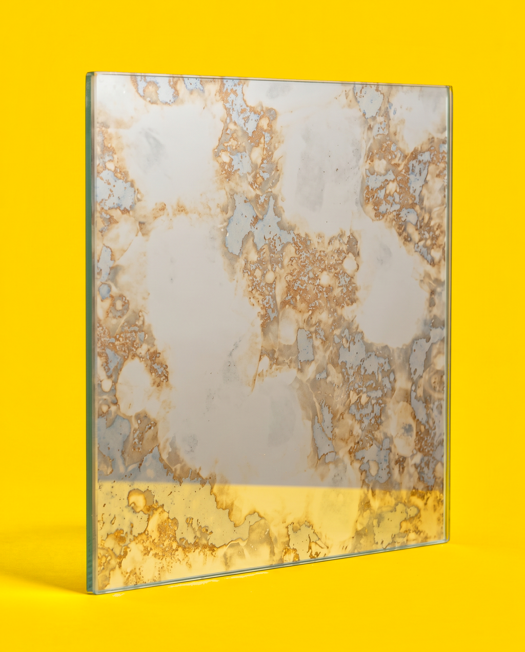 Antique mirror glass panel in the Golden Field pattern, silver mirror with gold, tan and brown veins, standing on a yellow background