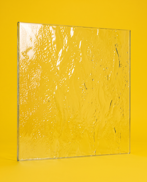 Aqualite pattern glass panel standing on a yellow background, rolled wave texture