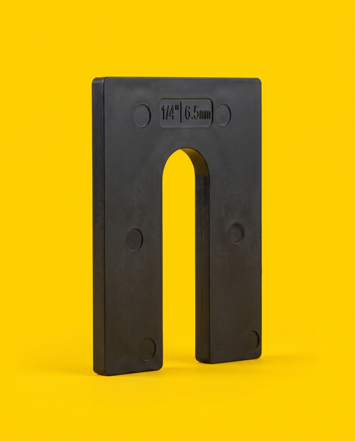 Black 1/4 inch horseshoe shim with the gauge embossed on the face, yellow background