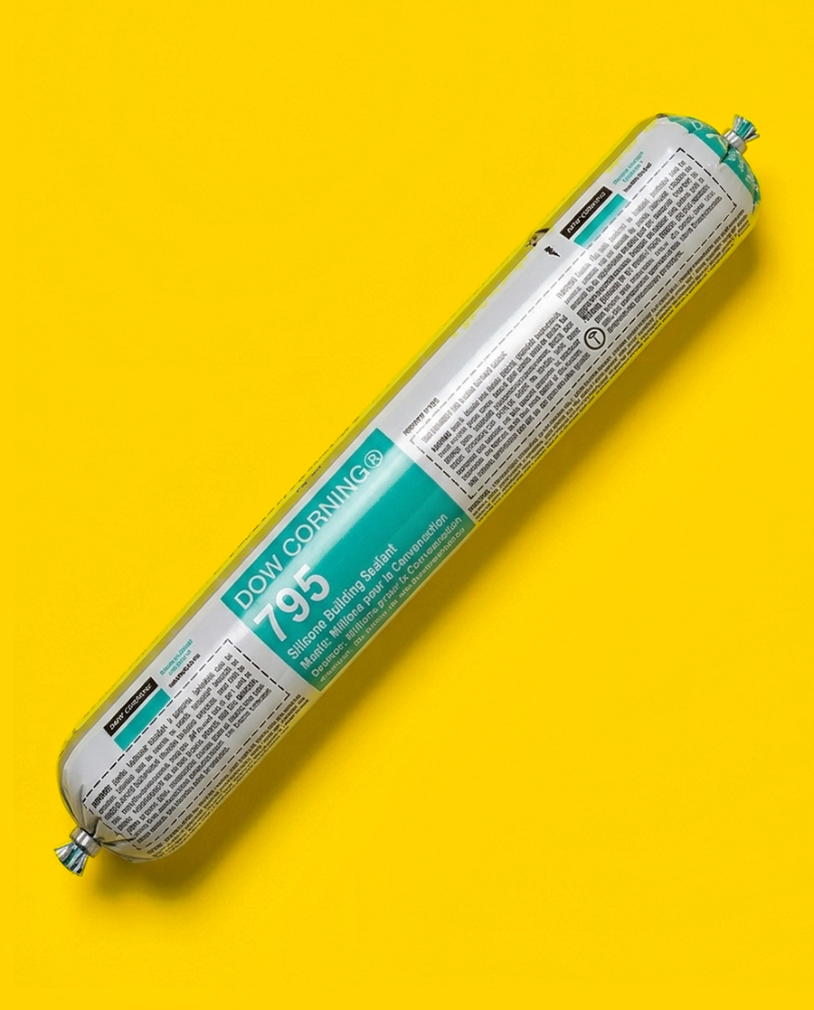 DOWSIL 795 silicone building sealant, sold for years as Dow Corning 795, 20 fl oz foil sausage on a yellow background